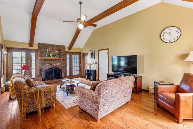 19 Edgewood St, Cromwell, CT 06416 - living area featuring a brick fireplace, wood finished floors, beam ceiling, baseboard heating, and a ceiling fan