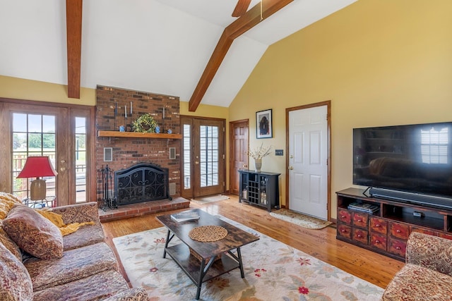 19 Edgewood St, Cromwell, CT 06416 - living room featuring beam ceiling, healthy amount of natural light, high vaulted ceiling, wood finished floors, and a brick fireplace