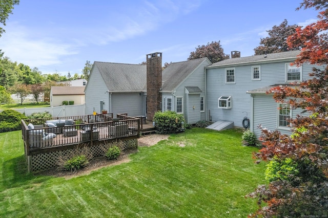 19 Edgewood St, Cromwell, CT 06416 - rear view of property with a wooden deck, a lawn, a chimney, and a garage