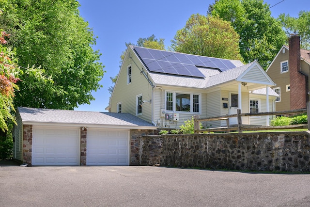 111 Wilcox St, Bristol, CT 06010 - view of front of home featuring solar panels, stone siding, and roof with shingles