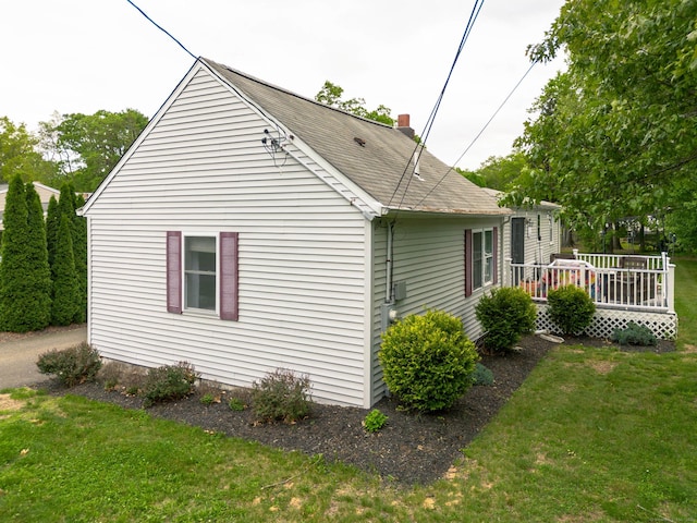40 Woodland Ave, North Haven, CT 06473 - view of home's exterior with a wooden deck, a yard, and roof with shingles