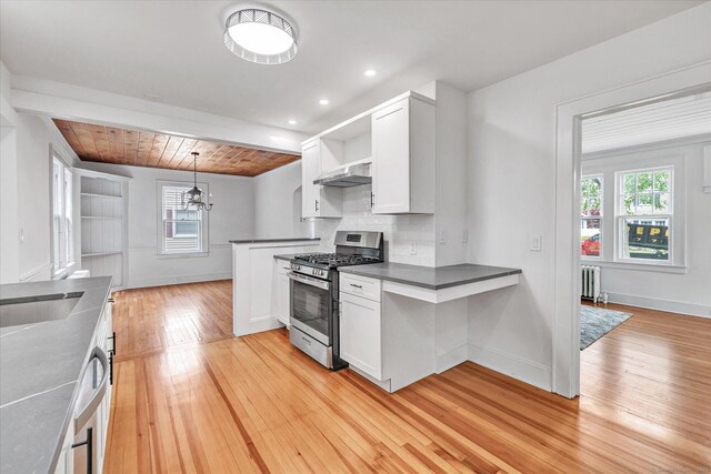 61 Reed St, Stratford, CT 06614 - kitchen featuring stainless steel gas range, radiator, open shelves, extractor fan, and healthy amount of natural light