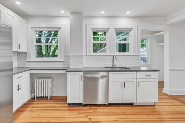 61 Reed St, Stratford, CT 06614 - kitchen with radiator, appliances with stainless steel finishes, a sink, light wood-type flooring, and recessed lighting