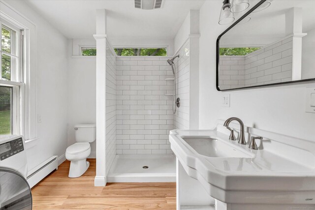 61 Reed St, Stratford, CT 06614 - full bath with a baseboard heating unit, healthy amount of natural light, a shower stall, and toilet
