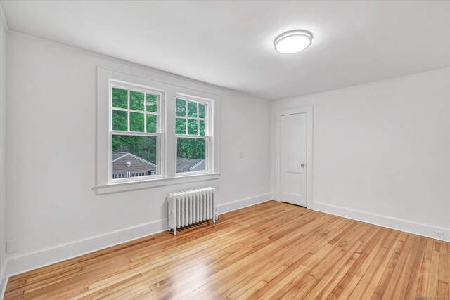 61 Reed St, Stratford, CT 06614 - unfurnished room with radiator heating unit, light wood finished floors, and baseboards