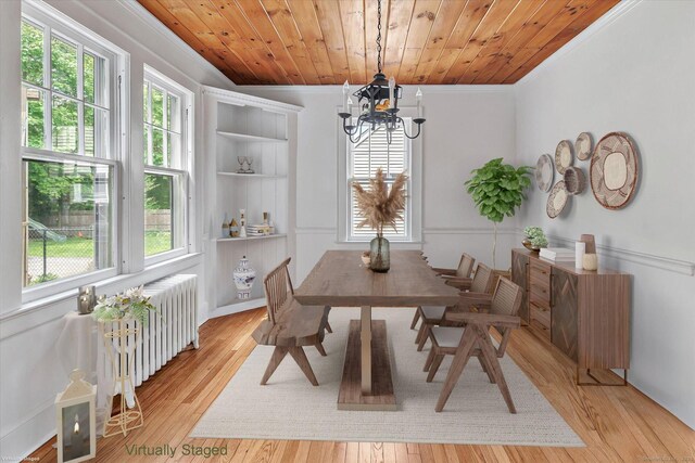 61 Reed St, Stratford, CT 06614 - dining room featuring crown molding, a chandelier, radiator heating unit, and light wood-style flooring
