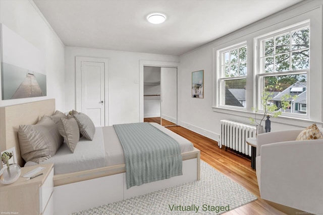 61 Reed St, Stratford, CT 06614 - bedroom featuring radiator, wood finished floors, two closets, and baseboards