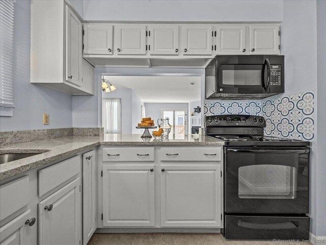 158 Paddock Ave Apt 2001, Meriden, CT 06450 - kitchen with black appliances, white cabinetry, light stone counters, and backsplash