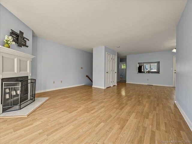 158 Paddock Ave Apt 2001, Meriden, CT 06450 - unfurnished living room featuring light wood-type flooring and baseboards
