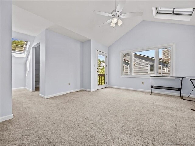 158 Paddock Ave Apt 2001, Meriden, CT 06450 - unfurnished living room with a skylight, carpet flooring, vaulted ceiling, baseboards, and ceiling fan