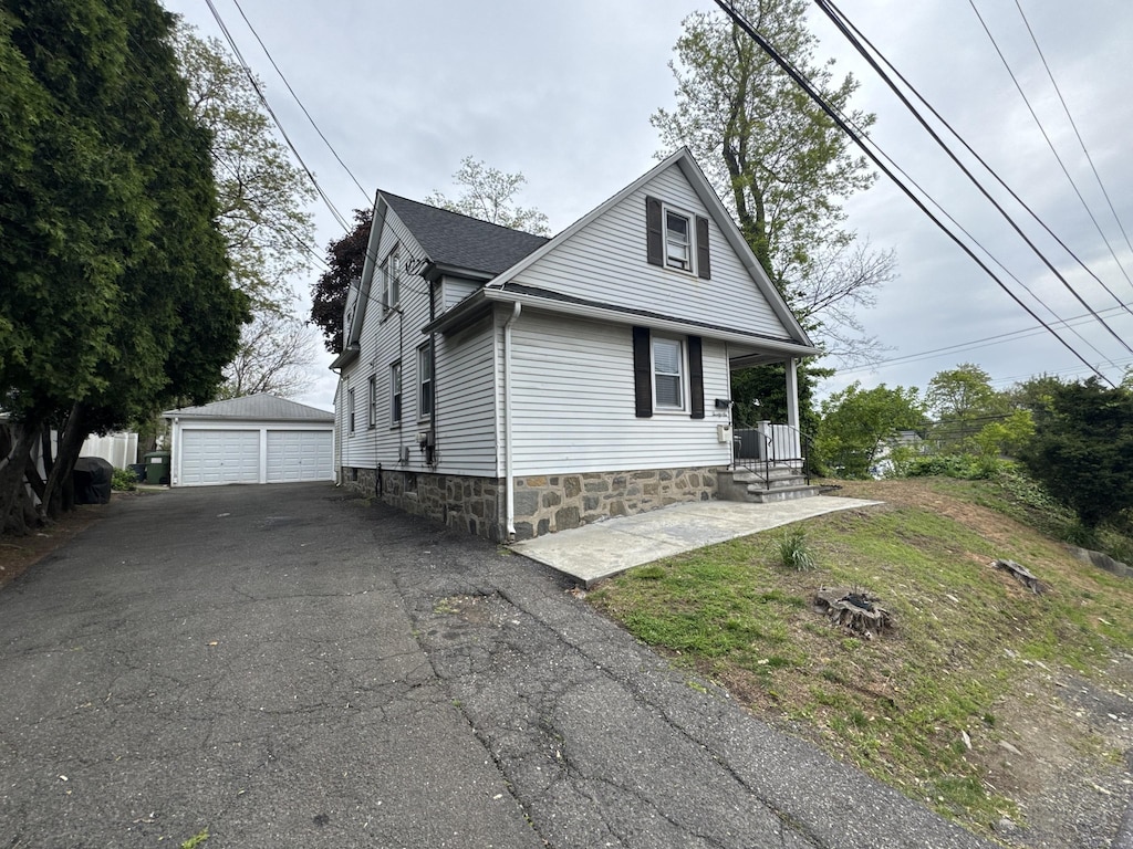 26 Longfellow Ave, Fairfield, CT 06825 - view of front of home featuring an outbuilding, a detached garage, and a porch