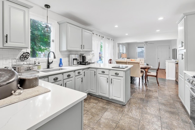 26 Longfellow Ave, Fairfield, CT 06825 - kitchen with a sink, a peninsula, tasteful backsplash, light countertops, and recessed lighting