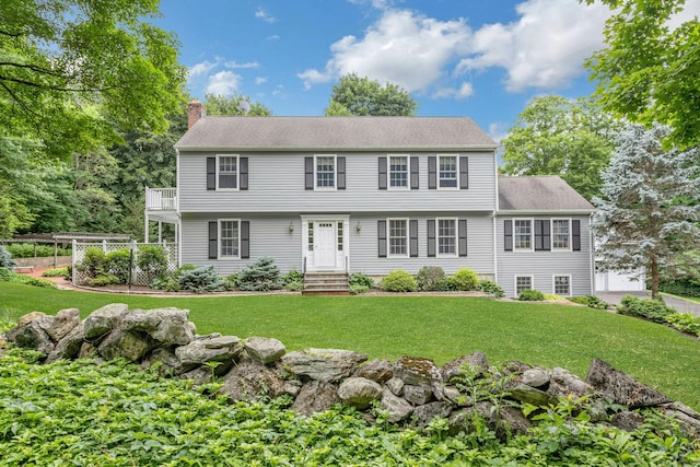 130 Haviland Rd, Ridgefield, CT 06877 - colonial home featuring a balcony, a chimney, a front yard, and roof with shingles