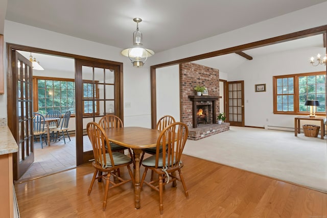 130 Haviland Rd, Ridgefield, CT 06877 - dining area featuring a brick fireplace, light wood-style floors, and a chandelier