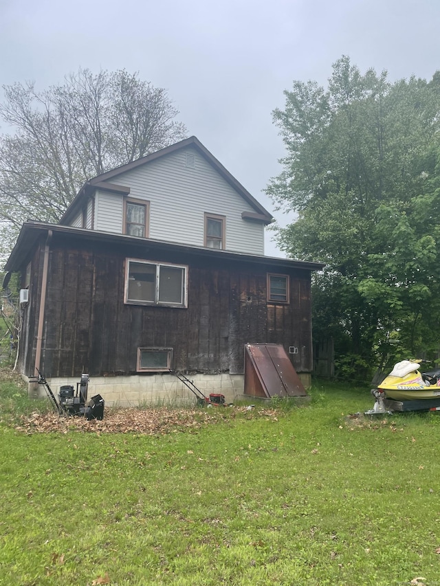 rear view of house featuring a yard