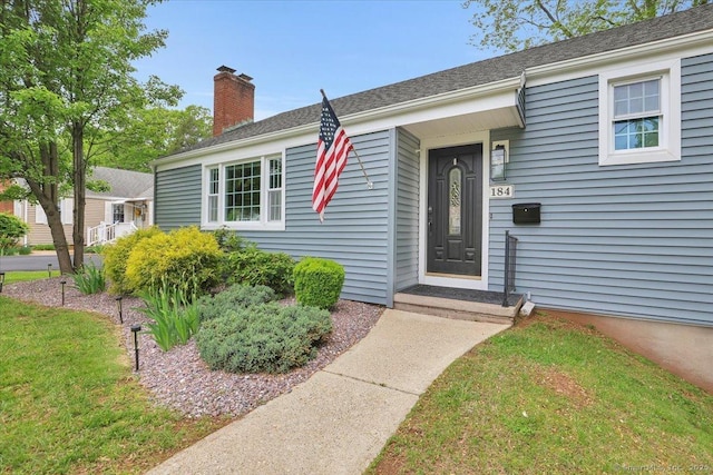 184 Goodale Dr, Newington, CT 06111 - property entrance with a chimney and a yard