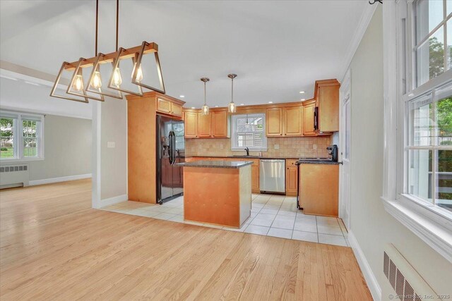 184 Goodale Dr, Newington, CT 06111 - kitchen with radiator heating unit, stainless steel dishwasher, black fridge with ice dispenser, backsplash, and light wood finished floors