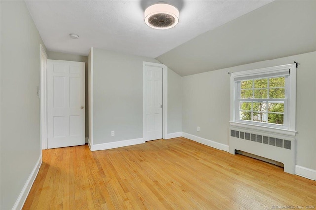 184 Goodale Dr, Newington, CT 06111 - unfurnished bedroom with radiator heating unit, baseboards, light wood-type flooring, and lofted ceiling