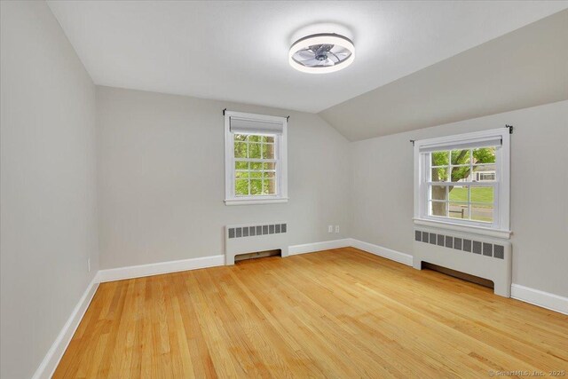 184 Goodale Dr, Newington, CT 06111 - bonus room with radiator heating unit, light wood-type flooring, baseboards, and vaulted ceiling