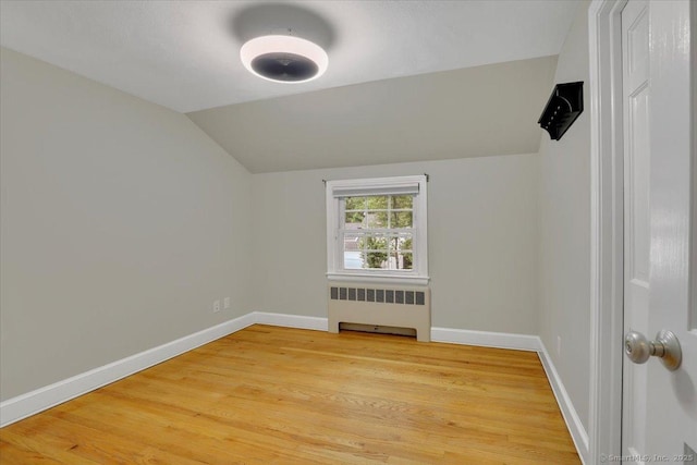 184 Goodale Dr, Newington, CT 06111 - spare room featuring radiator heating unit, lofted ceiling, light wood finished floors, and baseboards