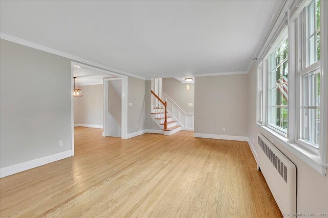 184 Goodale Dr, Newington, CT 06111 - unfurnished room with radiator heating unit, light wood-style floors, stairway, crown molding, and baseboards