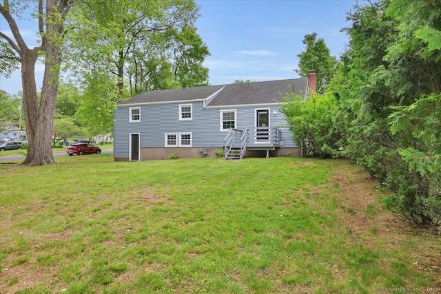 184 Goodale Dr, Newington, CT 06111 - rear view of house with a lawn, a chimney, a wooden deck, and roof with shingles