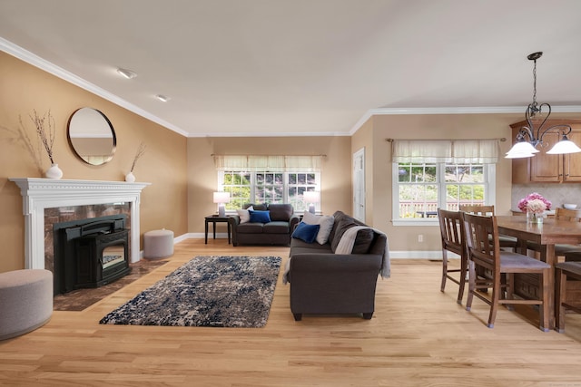 12 Everwood Dr, New Milford, CT 06776 - living room featuring light wood-type flooring, plenty of natural light, ornamental molding, baseboards, and a wood stove