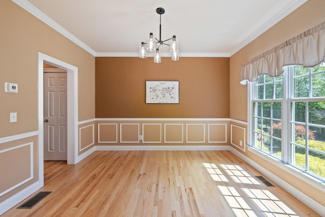 12 Everwood Dr, New Milford, CT 06776 - empty room featuring a chandelier, plenty of natural light, ornamental molding, light wood finished floors, and wainscoting