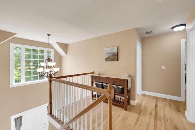 12 Everwood Dr, New Milford, CT 06776 - corridor featuring a chandelier, light wood finished floors, an upstairs landing, and baseboards