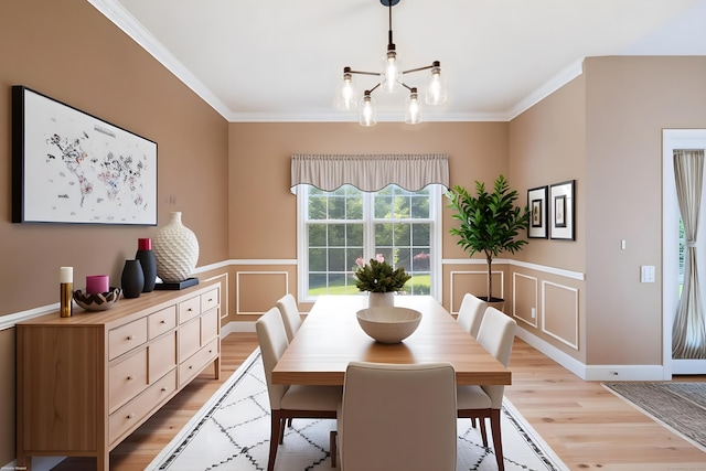 12 Everwood Dr, New Milford, CT 06776 - dining room featuring light wood-type flooring, ornamental molding, a chandelier, a decorative wall, and wainscoting