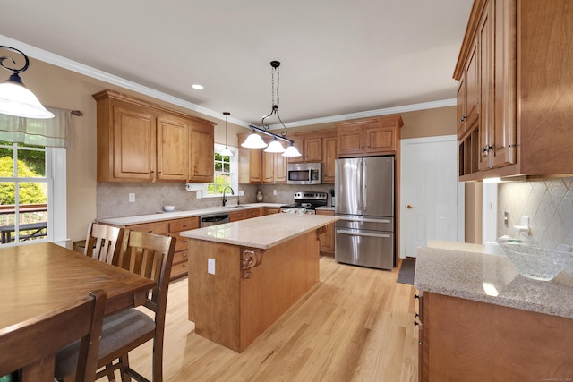12 Everwood Dr, New Milford, CT 06776 - kitchen featuring stainless steel appliances, a sink, light wood-type flooring, a kitchen island, and decorative backsplash