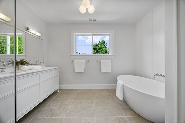 171 Compo Rd S, Westport, CT 06880 - full bathroom with double vanity, plenty of natural light, a soaking tub, and baseboards