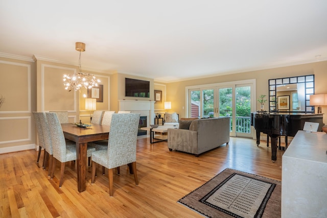 645 Prospect Ave Unit 9, West Hartford, CT 06105 - dining space featuring ornamental molding, light wood-style flooring, and a chandelier