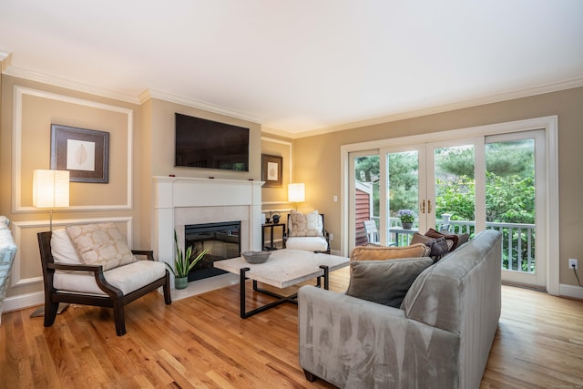 645 Prospect Ave Unit 9, West Hartford, CT 06105 - living room with french doors, crown molding, a fireplace, light wood-style flooring, and baseboards