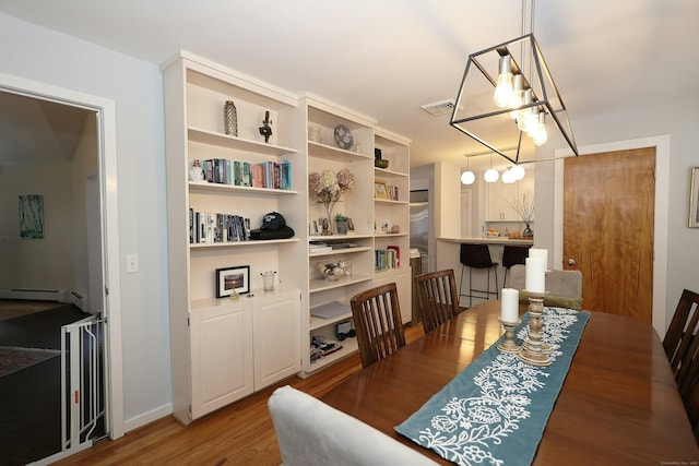 47 Old S Salem Road, Ridgefield, CT 06877 - dining room with a chandelier, wood finished floors, baseboard heating, and baseboards