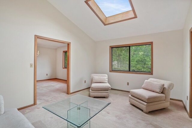 223 Sterling Rd, Trumbull, CT 06611 - living area with light carpet, healthy amount of natural light, a skylight, baseboards, and high vaulted ceiling