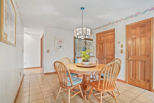 223 Sterling Rd, Trumbull, CT 06611 - dining space featuring baseboards, light tile patterned floors, and a chandelier