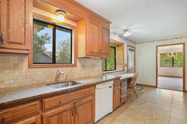 223 Sterling Rd, Trumbull, CT 06611 - kitchen featuring dishwasher, a sink, baseboards, backsplash, and brown cabinets