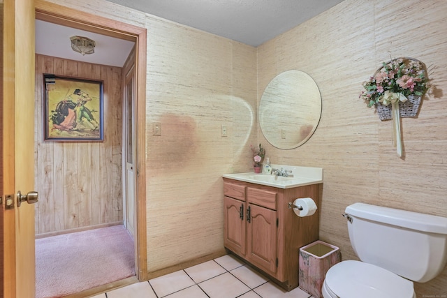223 Sterling Rd, Trumbull, CT 06611 - bathroom featuring toilet, vanity, tile patterned flooring, and wooden walls