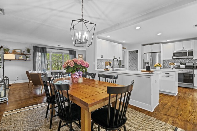 124 Killian Ave, Trumbull, CT 06611 - dining space with wood finished floors, a chandelier, recessed lighting, and baseboards