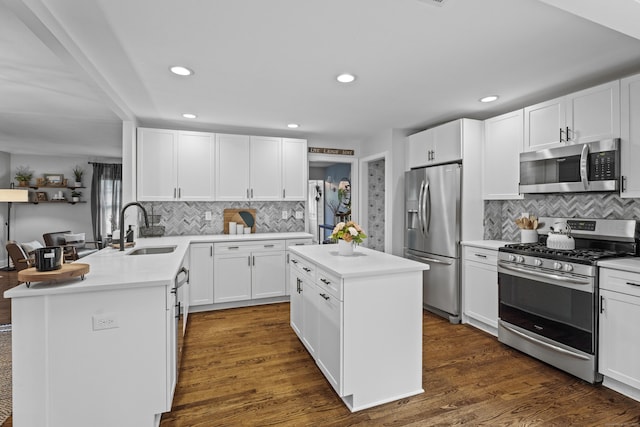124 Killian Ave, Trumbull, CT 06611 - kitchen featuring stainless steel appliances, a sink, decorative backsplash, white cabinets, and recessed lighting