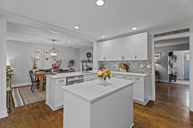 124 Killian Ave, Trumbull, CT 06611 - kitchen featuring stainless steel dishwasher, a peninsula, white cabinetry, decorative backsplash, and light countertops