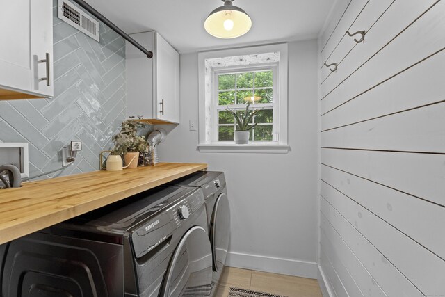 124 Killian Ave, Trumbull, CT 06611 - washroom with washing machine and dryer, cabinet space, and baseboards