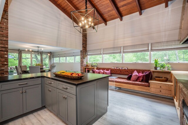31 Westcliff Dr, West Hartford, CT 06117 - kitchen with a chandelier, gray cabinets, wooden ceiling, light wood-type flooring, and dark countertops