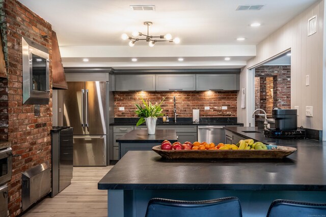 31 Westcliff Dr, West Hartford, CT 06117 - kitchen featuring stainless steel appliances, dark countertops, a sink, and light wood-type flooring