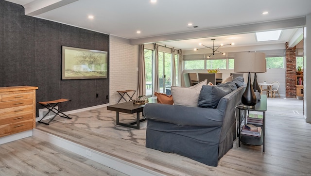 31 Westcliff Dr, West Hartford, CT 06117 - living room with wood finished floors, a skylight, and a chandelier