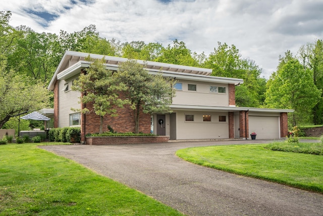 31 Westcliff Dr, West Hartford, CT 06117 - view of front facade featuring brick siding, driveway, a front yard, and a garage