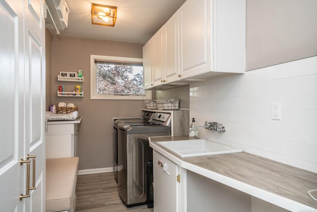 31 Westcliff Dr, West Hartford, CT 06117 - laundry room with cabinet space, washer and dryer, light wood-type flooring, and baseboards