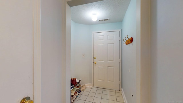 500 Prospect St Apt 4B, New Haven, CT 06511 - entryway featuring light tile patterned floors, a textured ceiling, and baseboards