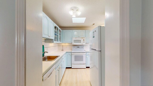 500 Prospect St Apt 4B, New Haven, CT 06511 - kitchen with white appliances, a sink, glass insert cabinets, light countertops, and a textured ceiling